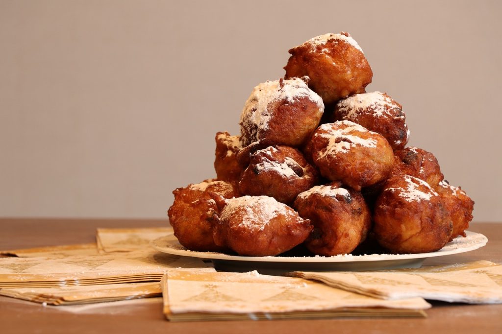 deep fried doughnut balls, old and new, powdered sugar